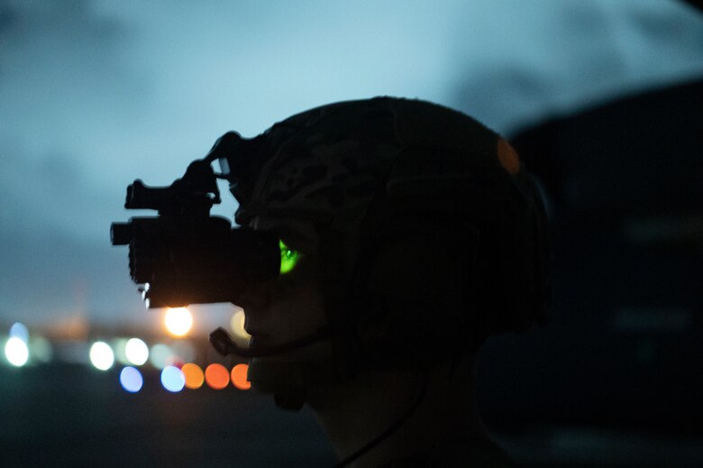 An Airman looks through night vision goggles