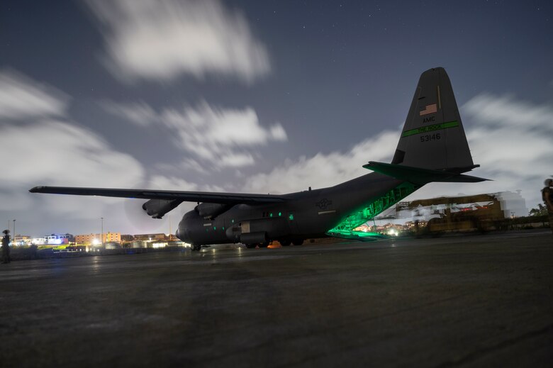 A C-130J sits on the flightline