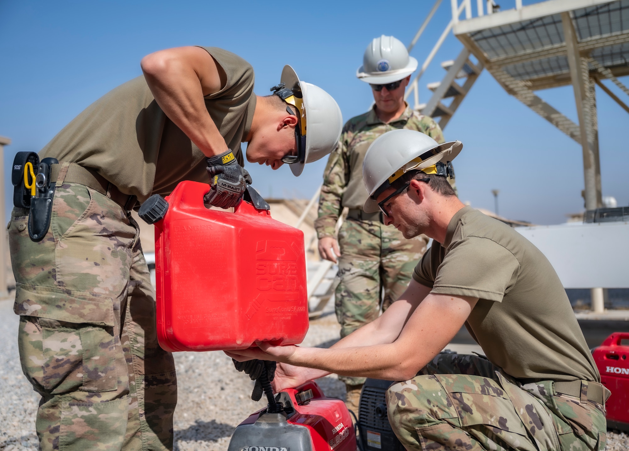 Members of the U.S. Air Forces Central, Air Force Forces A67 Engineering and Installations team fill a generator with gasoline at Ali Al Salem Air Base, Kuwait, Oct. 19, 2021.
