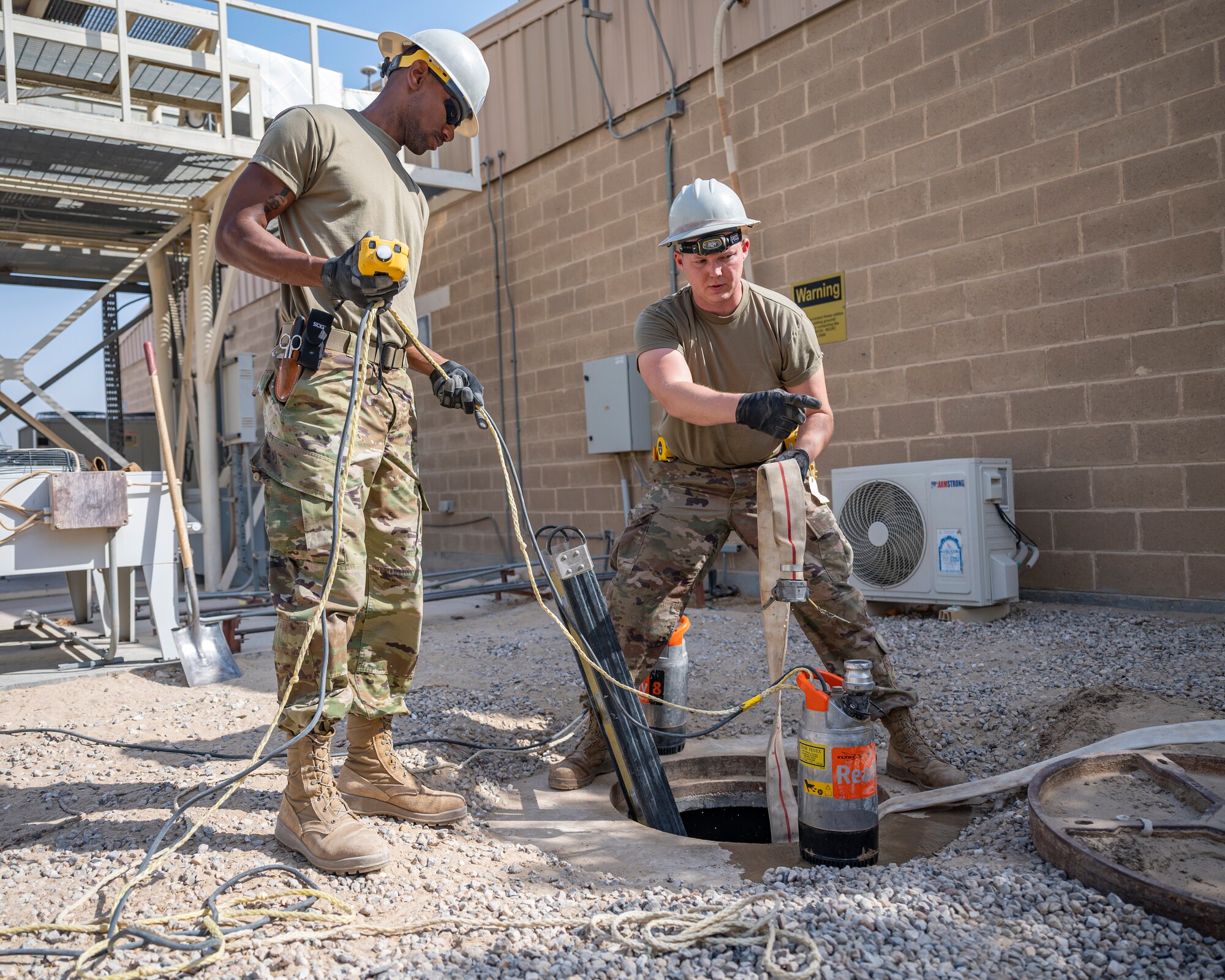 Members of the U.S. Air Forces Central, Air Force Forces A67 Engineering and Installation team prepare to enter a maintenance hole at Ali Al Salem Air Base, Kuwait, Oct. 19, 2021.