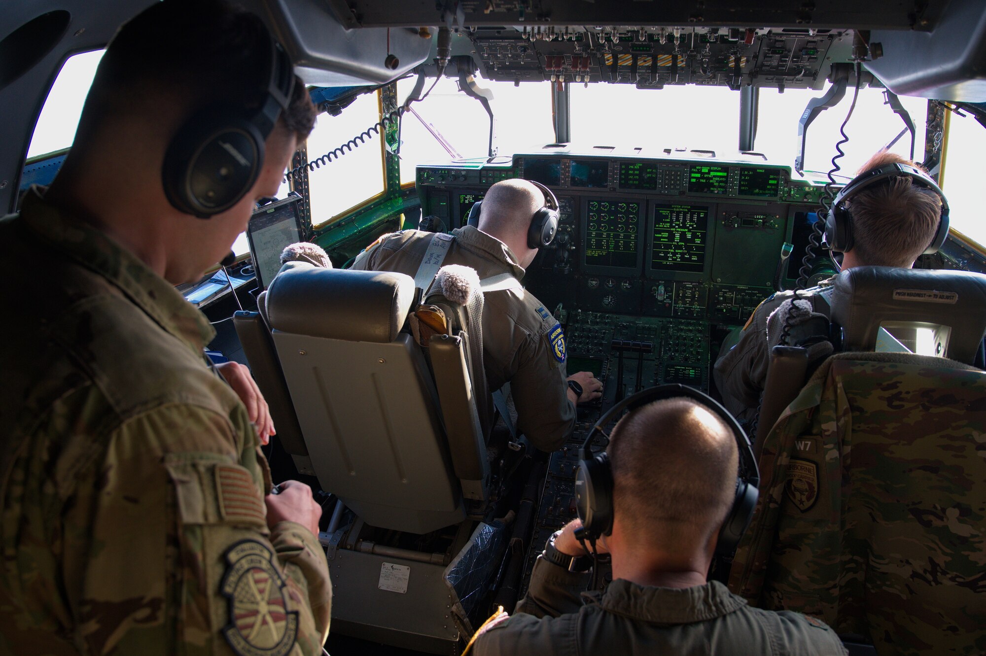 U.S. Air Force pilots from the 37th Airlift Squadron and an 86th Aircraft Maintenance Squadron flying crew chief solve an error while flying during Operation Castle Forge at Larissa Air Base, Greece, Oct. 15, 2021. Flying crew chiefs are specially trained maintenance personnel and are a regular part of flight crews.  Castle Forge is a U.S. Air Forces Europe-Air Forces Africa-led joint, multinational training event. Castle Forge is a U.S. Air Forces Europe-Air Forces Africa-led joint, multinational training event held in the Black Sea region to enable operations alongside NATO allies in Bulgaria, Romania and Greece. (U.S. Air Force photo by Senior Airman Branden Rae)