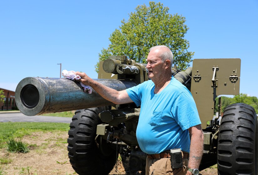 Retired Lt. Col. Dick Stoops greases the gun tube on a M114A2 Howitzer on Boone National Guard Center in Frankfort, Ky on May 10, 2021.  Stoops restored the decommissioned gun during the summer of 2021 (U.S. Army photo by U.S. Army Sgt. Jesse Elbouab).