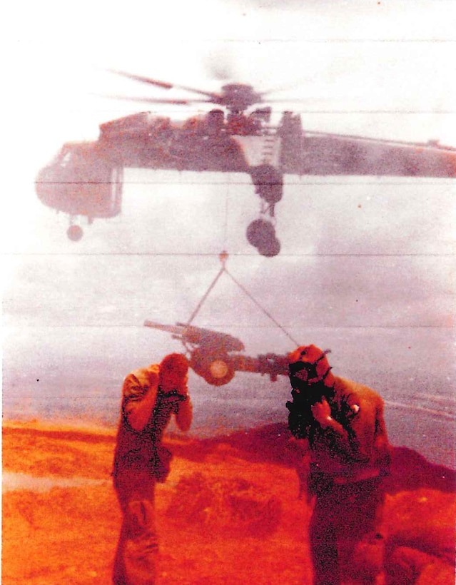 CH-54 Flying Crane transporting a Howitzer to Firebase Sledge, Vietnam on top of Bach Ma Mountain in August 1969 (Photo Courtesy of Retired Lt. Col. Dick Stoops).