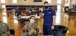 Petty Officer Second Class, Andrew Simons, a health services technician (right), assists Air Force Maj. Katherine Rorer (left) at the Tripler Army Medical Center, Hawaii, during Tripler’s MHS GENESIS “go-live” mass vaccination evolution on Sept. 28. Simons recently participated in the Coast Guard's MHS GENESIS PACWAVE “go-live” on Aug. 21 at Coast Guard Base Honolulu and was able to lend his electronic health records experience to the event.