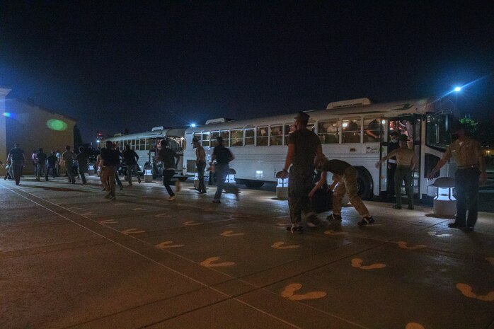 New U.S. Marine Corps recruits with Mike Company, 3rd Recruit Training Battalion, exit the buses during receiving at Marine Corps Recruit Depot, San Diego, Oct. 12, 2021.