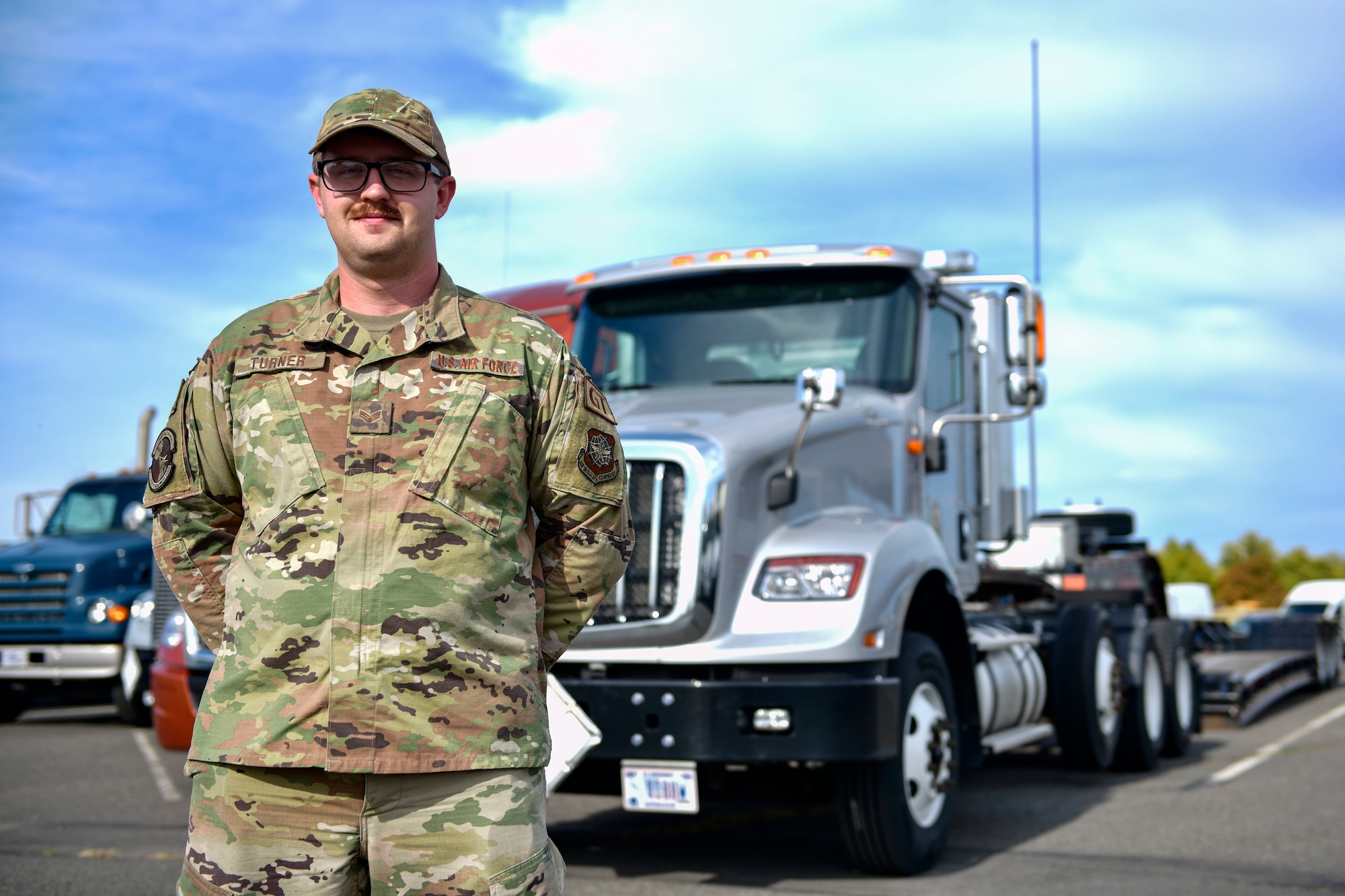U.S. Air Force Senior Airman Garret Turner, 92nd Logistics Readiness Squadron Ground Transportation specialist, poses in front of a tractor-trailer truck at Fairchild Air Force Base, Washington, Oct. 5, 2021. Out of 48 bases visited by the American Association of Motor Vehicle Administrators, Turner was the first Airman to pass the commercial driver’s license course. (U.S Air Force photo by Senior Airman Ryan Gomez)