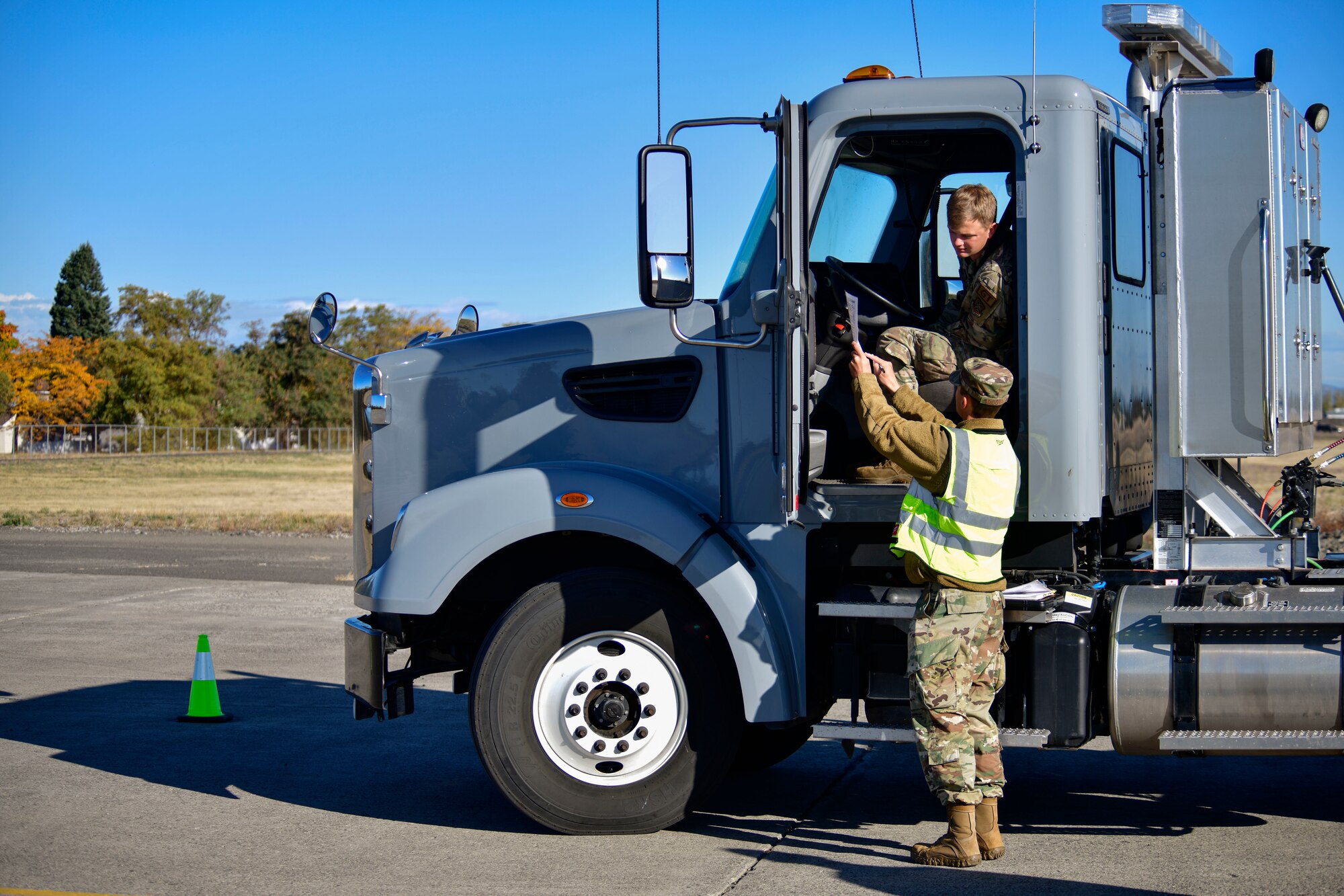 U.S. Air Force Staff Sgt. Joshua McDonald, 92nd Logistics Readiness Squadron Training, Validation and Operations examiner, explains the commercial driver’s license test requirements to U.S. Air Force Senior Airman Trevor Heying, 92nd LRS vehicle operator, at Fairchild Air Force Base, Washington, Oct. 7, 2021. This series of tests is being standardized across the Air Force to produce safer and more capable commercial vehicle drivers. (U.S Air Force photo by Senior Airman Ryan Gomez)