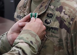 Chief Warrant Officer 4 Scott O. Harned, 1st Theater Sustainment Command (Forward), receives the Army Commendation Medal with the "C" device during an Oct. 7, 2021 presentation at 1st TSC's operational command post, Camp Arifjan, Kuwait. The award was presented by 1st TSC Deputy Commanding Officer Col. Sean P. Davis for his deployment to Afghanistan from July 28, 2021 to Aug. 30, 2021 to support U.S. forces in the last days of the U.S. military operations there. The "C" device denotes that Harned earned the medal under combat conditions.