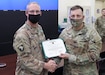 1st Theater Sustainment Command Deputy Commanding Officer Sean P. Davis awarded Chief Warrant Officer 4 Scott O. Harned, 1st TSC (Forward), the Army Commendation Medal with the "C" device for combat conditions at an Oct. 7, 2021, ceremony at 1st TSC's operational command post, Camp Arifjan, Kuwait. Davis presented the medal to Harned in recognition of his exceptionally meritorious service during his deployment to Afghanistan from July 28, 2021, to Aug. 30, 2021.