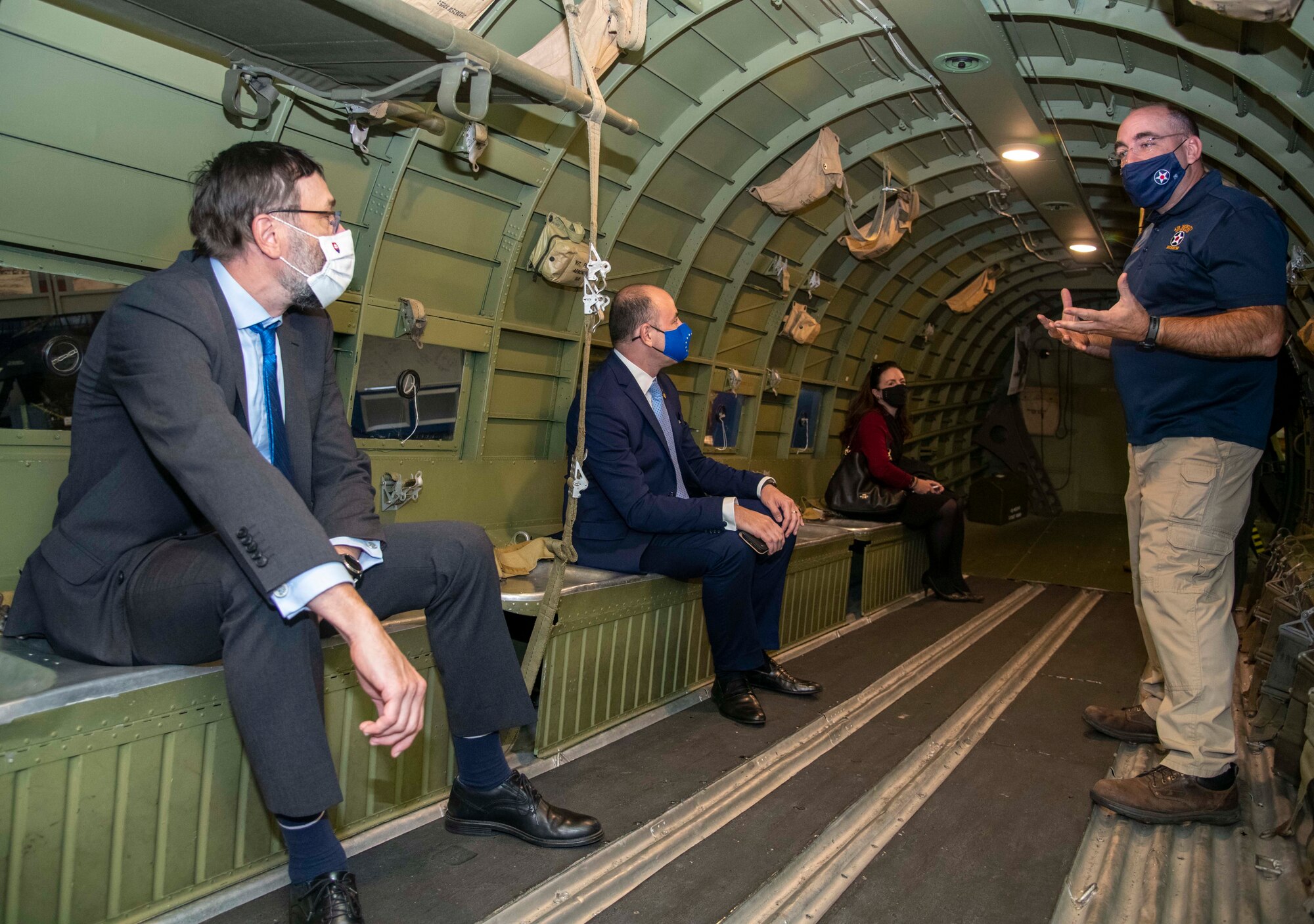 Eric Czerwinski, right, Air Mobility Command Museum deputy director, explains the role of the C-47 Skytrain to European Union Ambassadors to the United States during a visit to Dover Air Force Base, Delaware, Oct. 18, 2021. The C-47 was a transport aircraft used during World War II to move troops and equipment. (U.S. Air Force photo by Tech. Sgt. Nicole Leidholm)