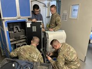 Eduardo Barraza-Cardenas, second from left, a biomedical equipment technician with the U.S. Army Medical Materiel Agency’s Forward Repair Activity-Medical (FRA-M) team, assists with diagnostics on an imaging system. Also pictured, from left, are Sgt. Joseph Black and Sgt. Joram Burg, 9th Hospital Center; and Spc. Michael Popinski, 393rd Medical Logistics Company.