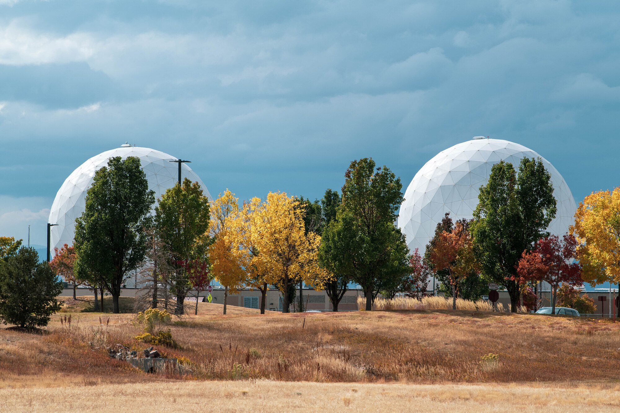 Two radomes providing strategic and theater missile warning for the United States and its international allies are photographed amid the autumn landscape on Oct. 19, 2021, on Buckley Space Force Base, Colo.