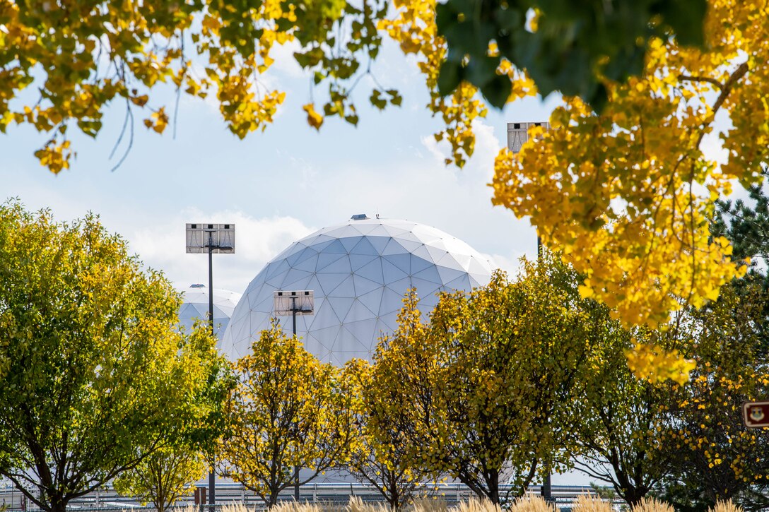 Two radomes providing strategic and theater missile warning for the United States and its international allies are photographed amid the autumn landscape on Oct. 19, 2021, on Buckley Space Force Base, Colo.