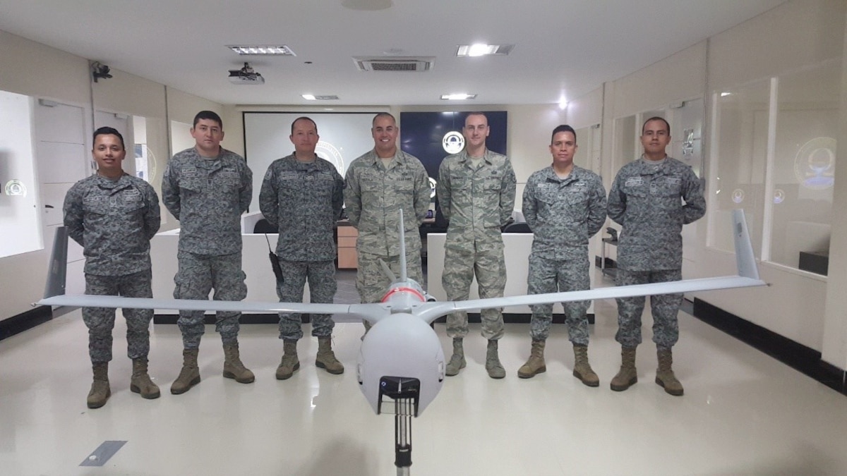 As a Language Enabled Airman Program Scholar, Senior Master Sgt. Adrian Gaxiola had the opportunity to travel to Colombia to teach an eight-week Geospatial Intelligence course focused on Full-Motion Video operations. He trained 43 members from the Colombian Air Force, National Police, Army and Navy. (Senior Master Sgt. Adrian Gaxiola pictured center with Tech. Sgt. Matthew Roman and members of the Colombian military)