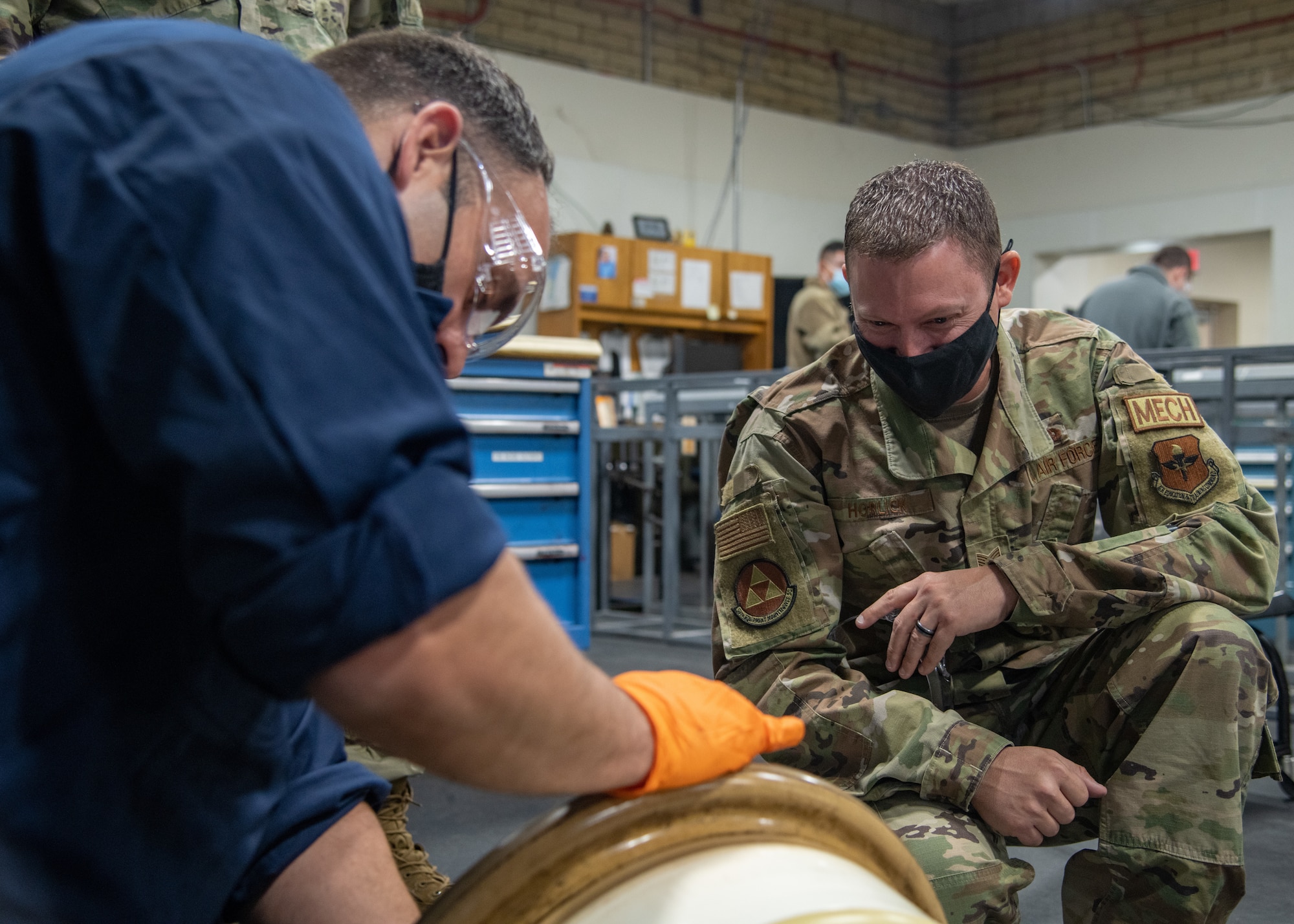 U.S. Air Force Tech. Sgt. Christopher Horlick, right, 56th Equipment Maintenance Squadron wheel and tire section chief, inspects the inside of an F-35A Lightning II main wheel hub assembly with U.S. Air Force Chief Master Sgt. Ray Lewis, left, 56th EMS superintendent, Oct. 14, 2021, at Luke Air Force Base, Arizona. The 56th EMS leadership team increased their wheel and tire knowledge and hands-on experience during a shop visit that focused on disassembling, cleaning and inspecting an F-35A wheel and tire assembly. The wheel and tire shop provides essential and reliable aircraft parts for the F-35A and F-16 Fighting Falcon, supporting the world’s greatest fighter pilots and combat-ready Airmen. (U.S. Air Force photo by Staff Sgt. Collette Brooks)