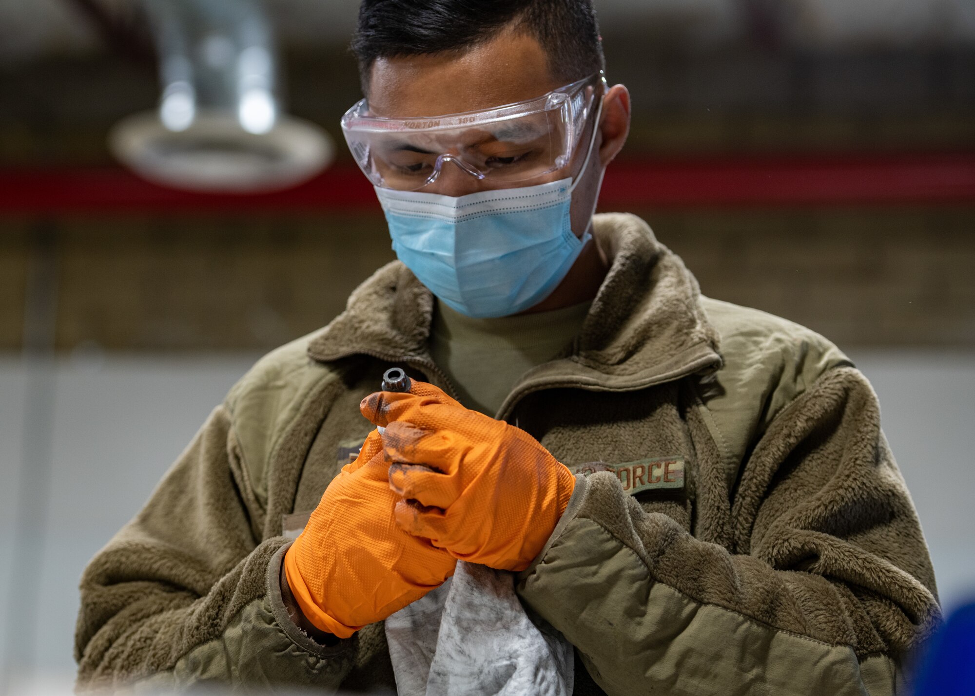 U.S. Air Force Senior Airman John Hizon, 56th Equipment Maintenance Squadron wheel and tire journeyman, inspects a bolt Oct. 14, 2021, at Luke Air Force Base, Arizona. The wheel and tire shop team demonstrated to 56th EMS leadership how they disassemble, clean, inspect, reassemble and store aircraft tires. The wheel and tire shop provides essential and reliable aircraft parts for the F-35A Lightning II and F-16 Fighting Falcon, supporting the world’s greatest fighter pilots and combat-ready Airmen. (U.S. Air Force photo by Staff Sgt. Collette Brooks)