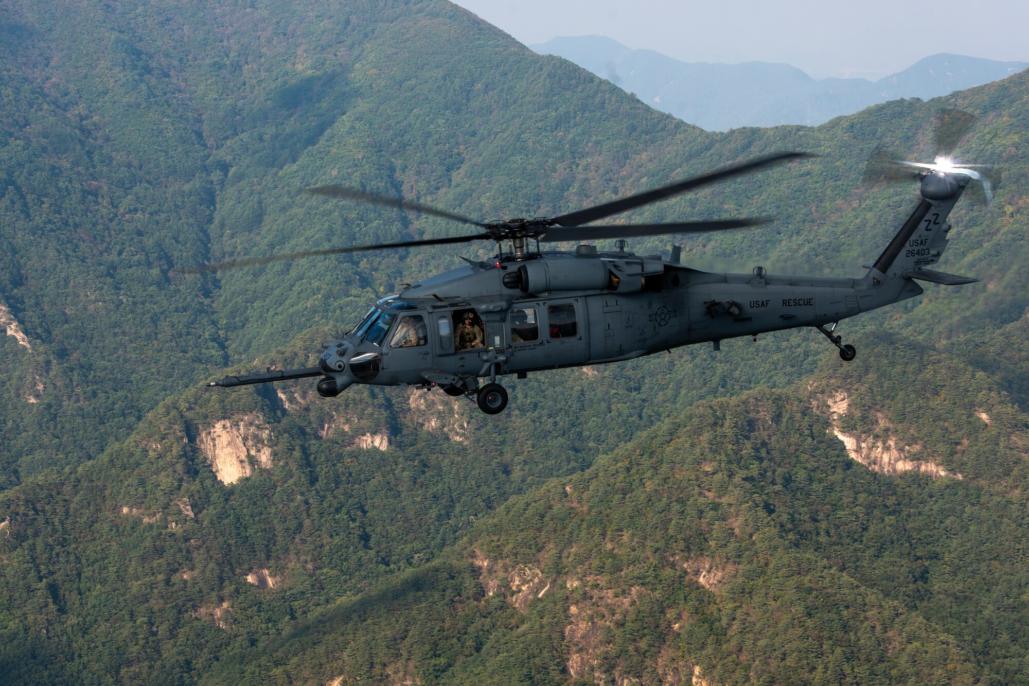 An HH-60G Pave Hawk flies over the Republic of Korea during a combat search and rescue training event