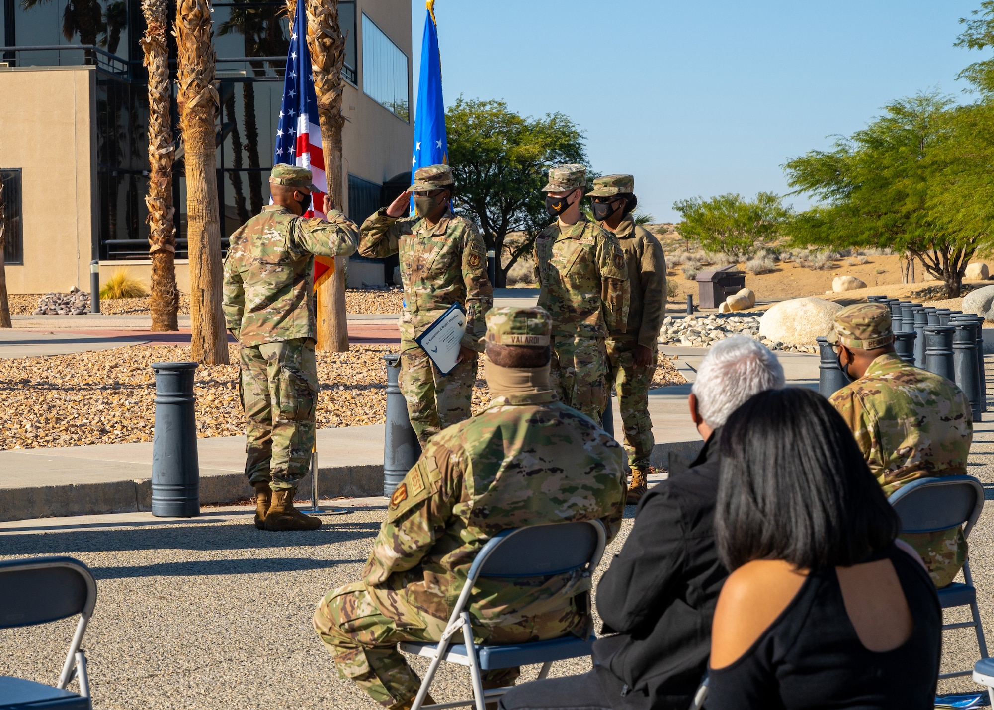 Senior Airman Jessica Gardner, Public Health Technician, 412th Medical Group, salutes Col. Randel Gordon, 412th Test Wing Vice Commander, after receiving her Community College of the Air Force degree, Oct. 14. (Air Force photo by Katherine Franco)