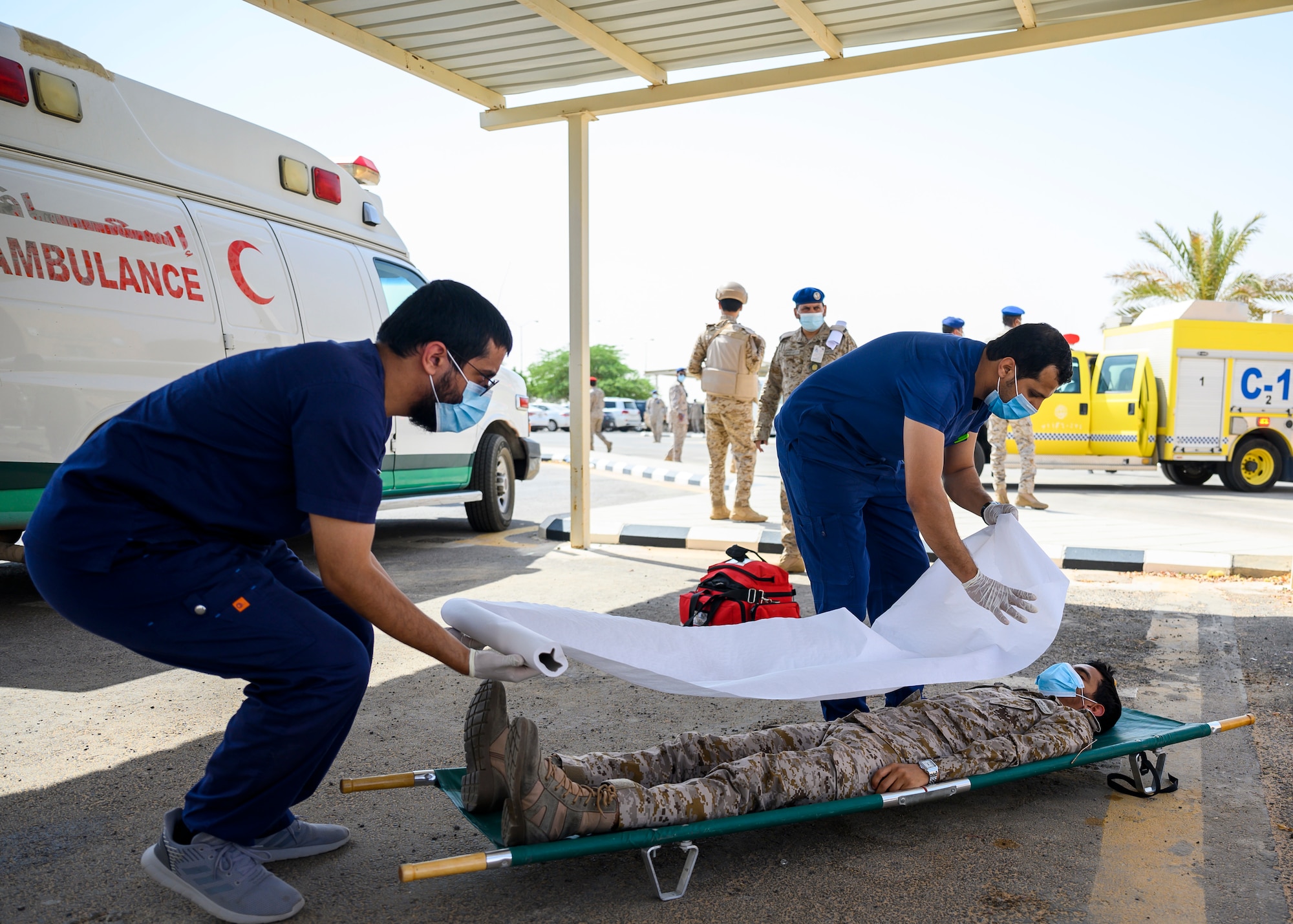Royal Saudi Air Force medical personnel participate in an emergency response bilateral exercise with the U.S. Air Force 378th Expeditionary Civil Engineer Squadronfire department, Prince Sultan Air Base, Kingdom of Saudi Arabia, Sept. 6, 2021. The exercise was integral to maintaining a working relationship between RSAF and USAF first responders and ensuring seamless integration in case of future emergencies at PSAB. (U.S Air Force photo by Senior Airman Samuel Earick)