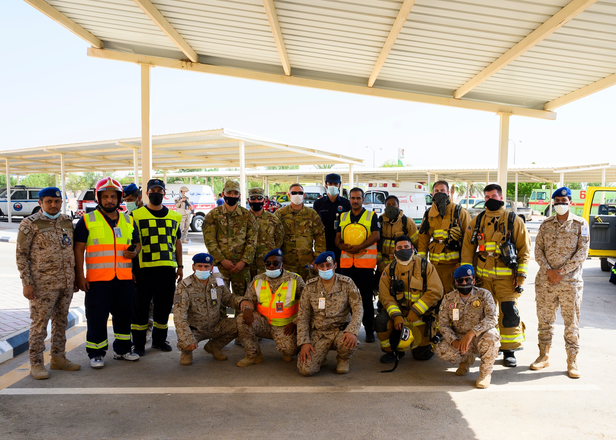 Members of the 378th Expeditionary Civil Engineer Squadron and Royal Saudi Air Force pose for a group photo after an emergency response bilateral exercise, Prince Sultan Air Base, Kingdom of Saudi Arabia, Sept. 6, 2021. The exercise was integral to maintaining a working relationship between RSAF and USAF first responders and ensuring seamless integration in case of future emergencies at PSAB. (U.S Air Force photo by Senior Airman Samuel Earick)