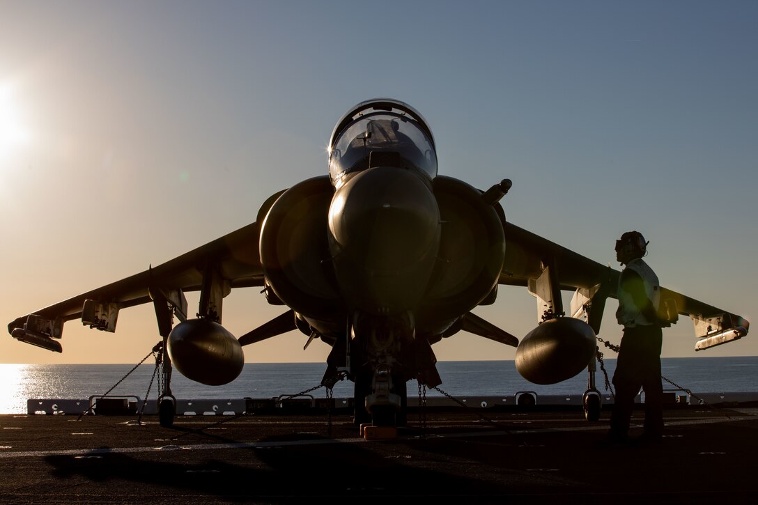 A U.S. Marine Corps pilot with the Aviation Combat Element assigned to the 22nd Marine Expeditionary Unit (MEU), conducts a readiness check of an AV-8B Harrier before beginning flight operations aboard amphibious assault ship USS Kearsarge (LHD 3), Oct. 19, 2021. Kearsarge, the flagship for the 22nd MEU and Amphibious Squadron (PHIBRON) 6, is underway for PHIBRON-MEU Integrated Training (PMINT) in preparation for a future deployment. PMINT is the first at-sea period in the MEU’s Predeployment Training Program; it aims to increase interoperability and build relationships between Marines and Sailors. (U.S. Marine Corps photo by Cpl. Yvonna Guyette)