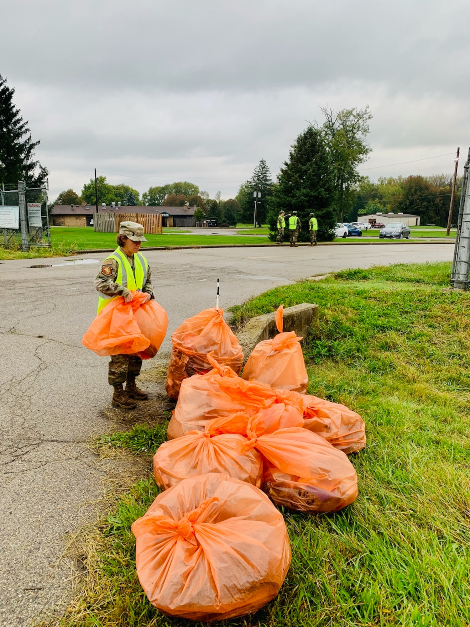 Senior Master Sgt. Shelly Gent of the National Air and Space Intelligence Center organizes multiple trash bags that were used to clean up a portion of state Route 444. A group of NASIC volunteers coordinated with the Ohio Department of Transportation on an Adopt–A-Highway outing to assist the local community. (Contributed photo)