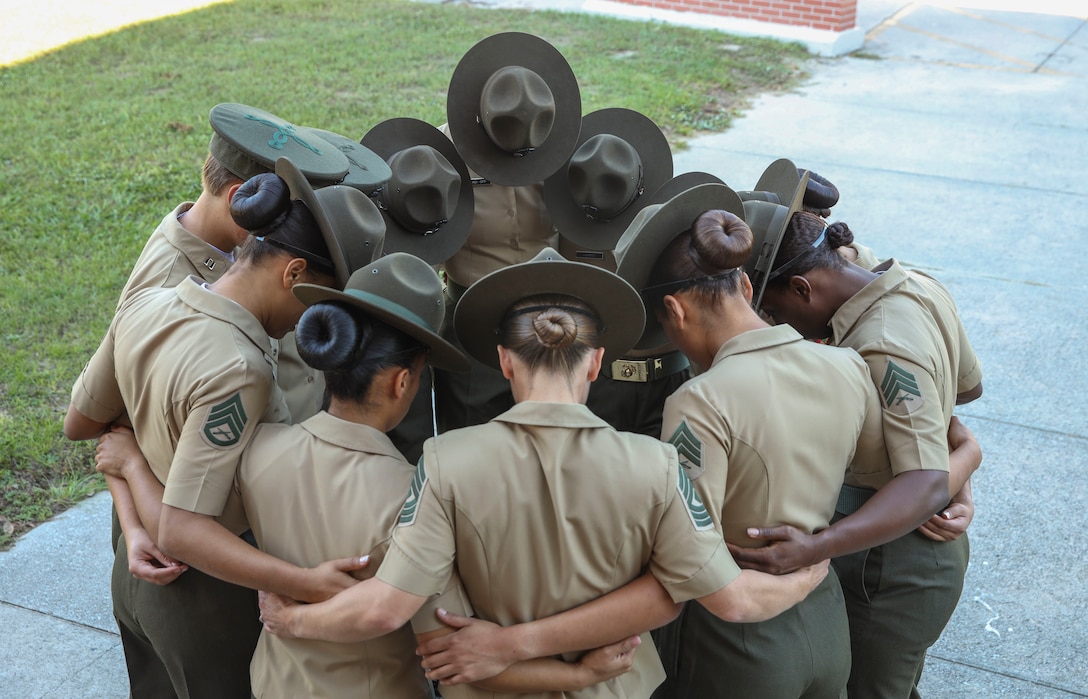 Marines with Oscar Company, 4th Recruit Training Battalion, pray before introducing themselves to their new platoons on Marine Corps Recruit Depot Parris Island, S.C., Oct. 16, 2021. Oscar Company will spend Forming Day learning the rules and regulations of recruit training. (U.S. Marine Corps photo by Lance Cpl. Ryan Hageali)