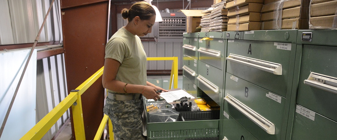 Pfc. Kayla Carroll inventories parts during annual training.