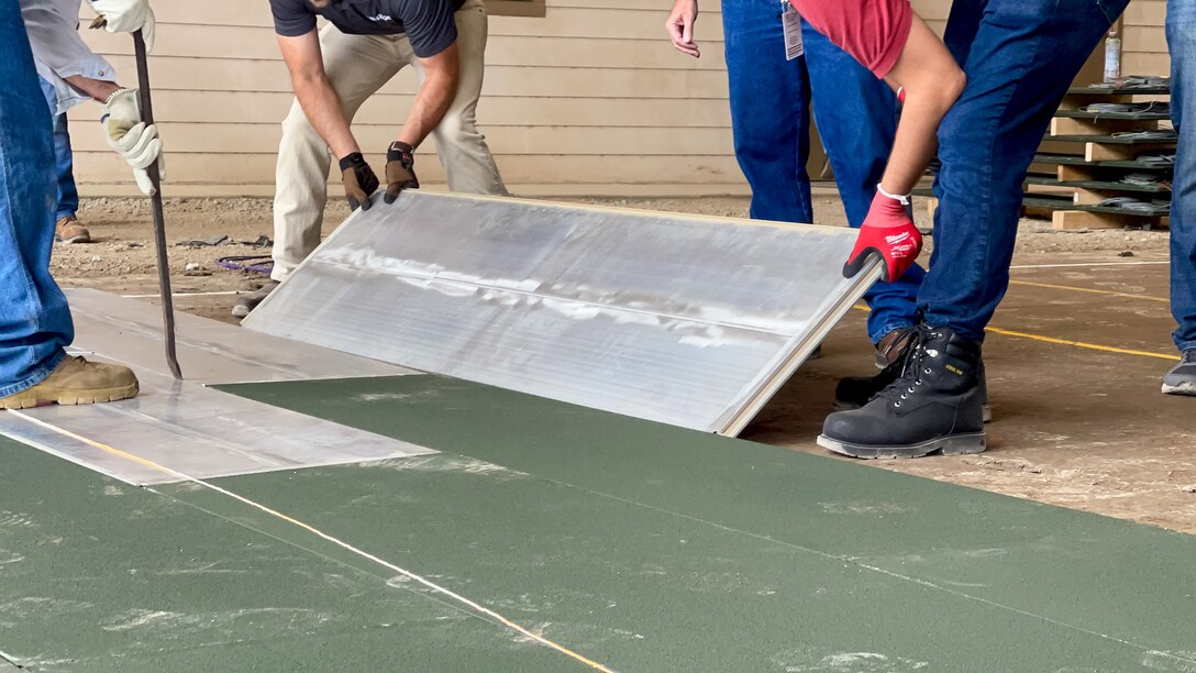 Researchers assemble a new prototype lightweight airfield matting system prior to testing