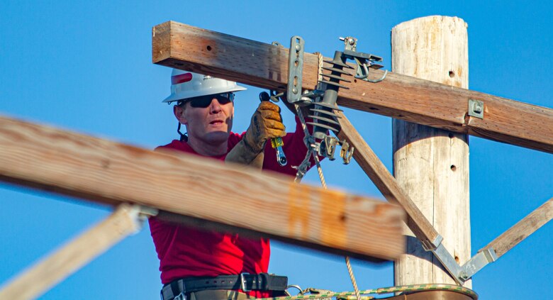 Sgt. 1st Class Mathew Walker, a Soldier assigned to Alpha Company, 249th Engineer Battalion, Prime Power, competes in the Journeyman Pole Climb Obstacle Course during the International Lineman's Rodeo alongside industry professionals at the National Agricultural Center and Hall of Fame in Bonner Springs, Kan., on Oct. 16, 2021. The event tests the Lineman’s ability to perform the required task within a set time period.