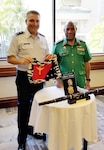 Maj. Gen Gilbert Toropo, the Papua New Guinea chief of defense, presents Maj. Gen. Paul Knapp, Wisconsin’s adjutant general, with a gift in September 2021 in Hawaii. Knapp visited Hawaii to meet with Toropo and attend a series of conferences in conjunction with the Wisconsin National Guard’s partnership with Papua New Guinea through the State Partnership Program.