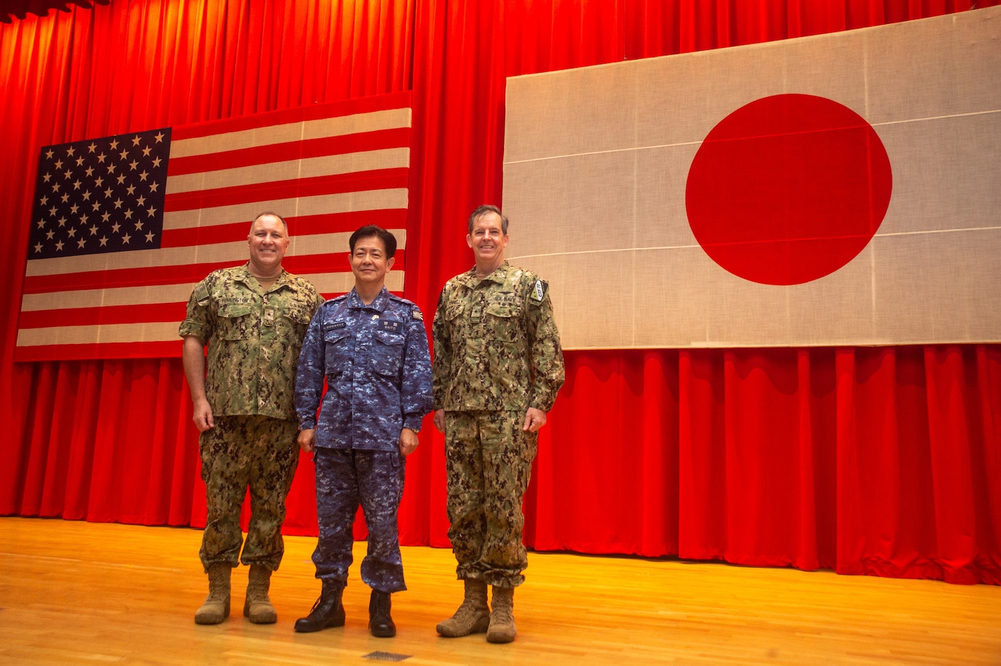 YOKOSUKA, Japan (Oct. 21, 2021) Rear Adm. Michael Donnelly, Commander, Task Force (CTF) 70, right, poses for a photo with Vice Adm. SAITO Akira, commander of Japan Maritime Self-Defense Force (JMSDF) Fleet Escort Force and Rear Adm. Will Pennington following a change of command ceremony for CTF 70 in the Benny Decker Theater on Yokosuka Naval Base, Oct. 21. (U.S. Navy photo by Mass Communication Specialist 3rd Class Askia Collins)