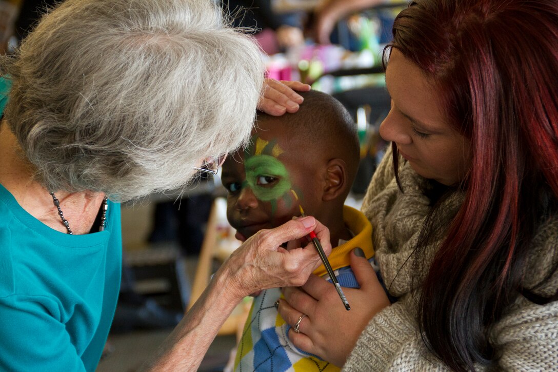 A military child receives a face-painting during a Survivors Outreach Services event in Louisville, Ky., Nov. 2, 2014. Families from 10 states gathered at Churchill Downs race track for the fifth annual Survivors Day at the Races.