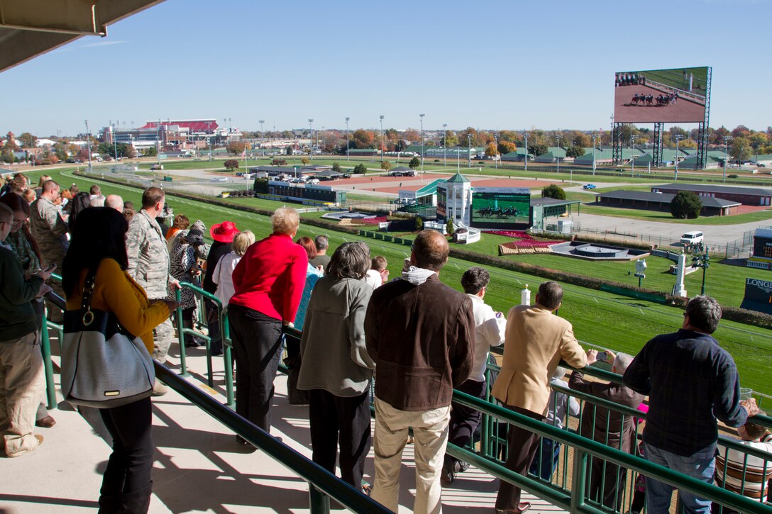 Family members of fallen U.S. service members and military leadership gather on the rail of Millionaires Row at Churchill Downs for a horse race during the Survivors Day at the Races in Louisville, Ky., Nov. 2, 2014. Families from 10 states attended the fifth annual event organized by Survivors Outreach Services.