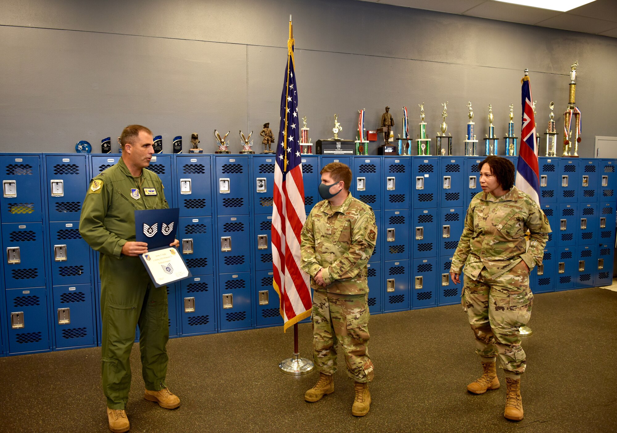 Col. Daniel Dobbels (left), 15th Wing commander, and Chief Master Sgt. Sheronne King (right), 15th WG command chief, award Tech. Sgt. Jeremy Soyke (center), 15th Aircraft Maintenance Squadron crew chief, his Stripes for Exceptional Performers promotion at Joint Base Pearl Harbor-Hickam, Hawaii, 15 Oct., 2021. STEP promotions are awarded to enlisted Airmen who demonstrate exceptional potential to the grades of Staff Sgt. or Tech. Sgt. (U.S. Air Force photo by 1st Lt. Benjamin Aronson)