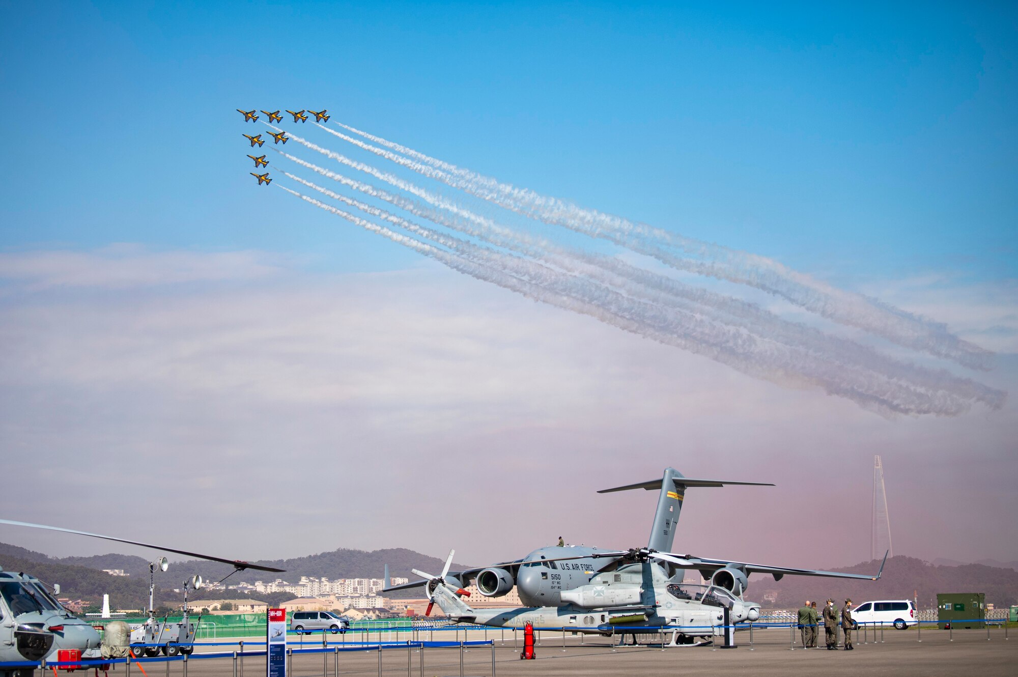 U.S. military members watch as the Republic of Korea Air Force Black Eagles perform during the Seoul International Aerospace and Defense Exhibition 2021 at Seoul Air Base, ROK, Oct. 18. Seoul ADEX 21 is the largest, most comprehensive event of its kind in Northeast Asia, attracting aviation and industry professionals, key defense personnel, aviation enthusiasts and the general public alike. (U.S. Air Force photo by Staff Sgt. Gabrielle Spalding)