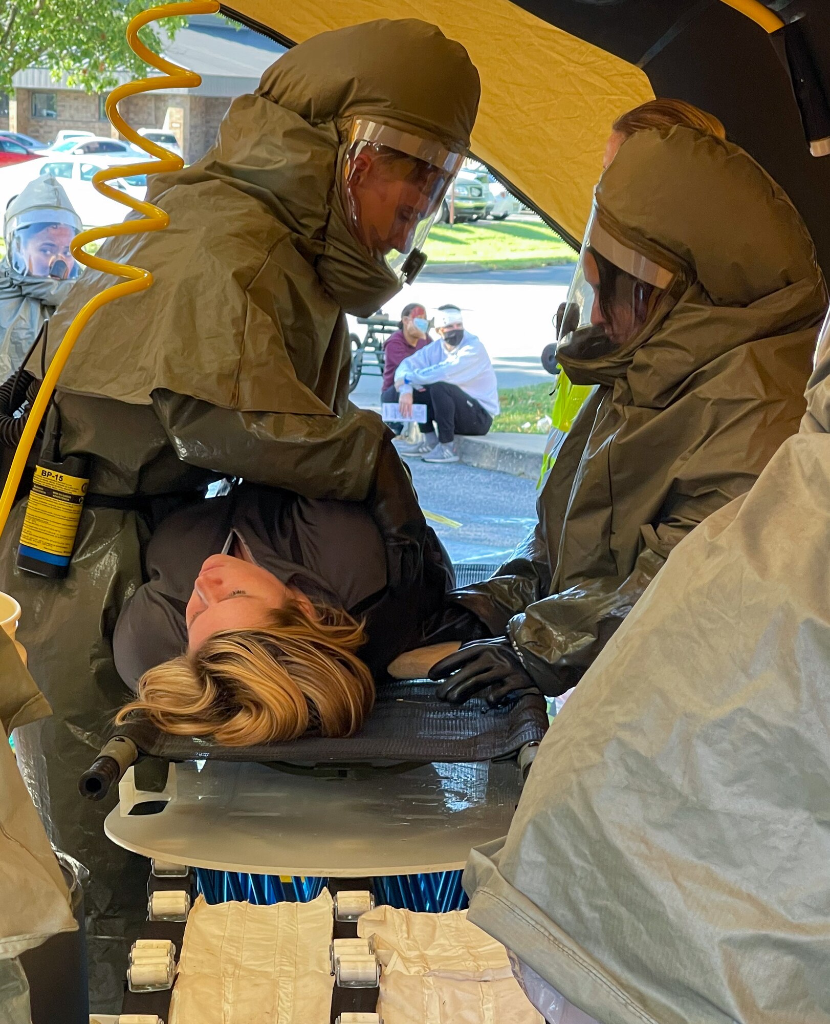 Medics in hazmat gear treat patient