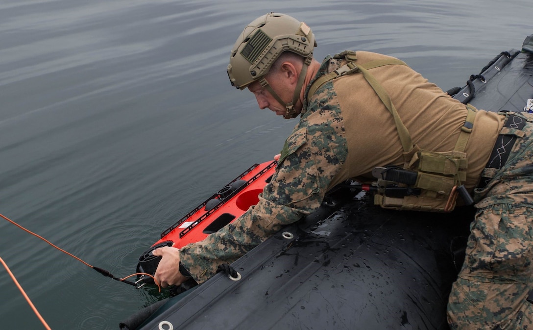 Staff Sgt. Seth Barnes, an explosive ordnance disposal technician from Littoral Explosive Ordnance Neutralization Platoon, 7th Engineer Support Battalion, 1st Marine Logistics Group, releases the Remotely Operated Vehicle into the water during a demonstration in San Diego, Calif., Oct. 6, 2021. The ROV asset aids the Marine Corps in naval force integration by giving Marines the capabilities to work alongside Navy EOD.