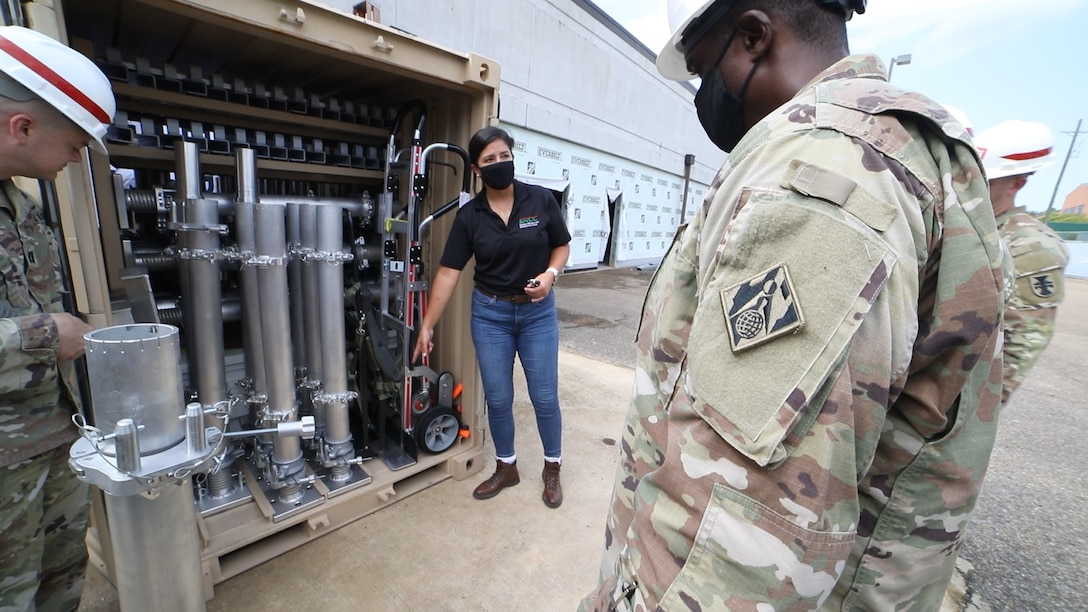 Dr. Genny Pezzola, U.S. Army Engineer Research and Development Center Program Manager for the Expedient Passive Protection Program, talks through the Expedient Retrofit for Existing Buildings system components with members of the 412th Theater Engineer Command. (U.S. Army Corps of Engineers photo)