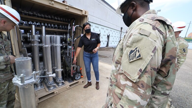 Dr. Genny Pezzola, U.S. Army Engineer Research and Development Center Program Manager for the Expedient Passive Protection Program, talks through the Expedient Retrofit for Existing Buildings system components with members of the 412th Theater Engineer Command. (U.S. Army Corps of Engineers photo)