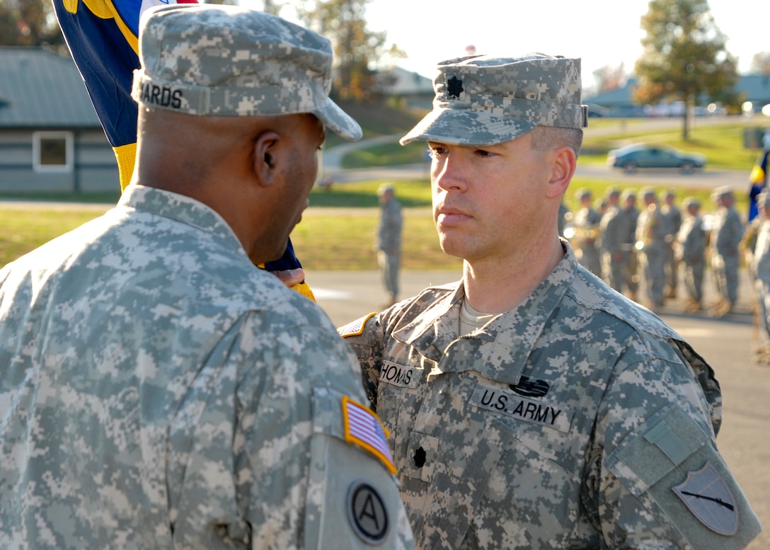 Kentucky Army National Guard Lt. Col. Scott C. Thomas receives the 751st Troop Command guidon from Col. John Edwards, the commander of the 75th Troop Command, during a change of command ceremony at Wendell H. Ford Regional Training Center in Greenville, Ky., Oct. 27, 2012. Lt. Col. Thomas assumed command of the 751st. (U.S. Army Photo by Sgt. Cody Stagner, 133rd Mobile Public Affairs Detachment/Released)