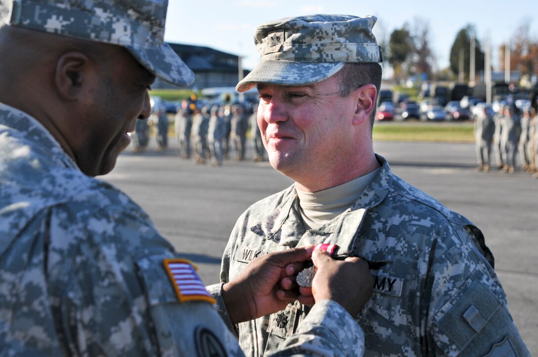 Kentucky Army National Guard Lt. Col. Brent A. Wilkins receives the Meritorious Service Medal from Col. John Edwards, commander of the 75th Troop Command, at Wendell H. Ford Regional Training Center in Greenville, Ky., Oct. 27, 2012. Lt. Col. Wilkins was presented this award during a change of command ceremony in which he released his command to Lt. Col. Scott C. Thomas. (U.S. Army Photo by Sgt. Cody Stagner, 133rd Mobile Public Affairs Detachment/Released)
