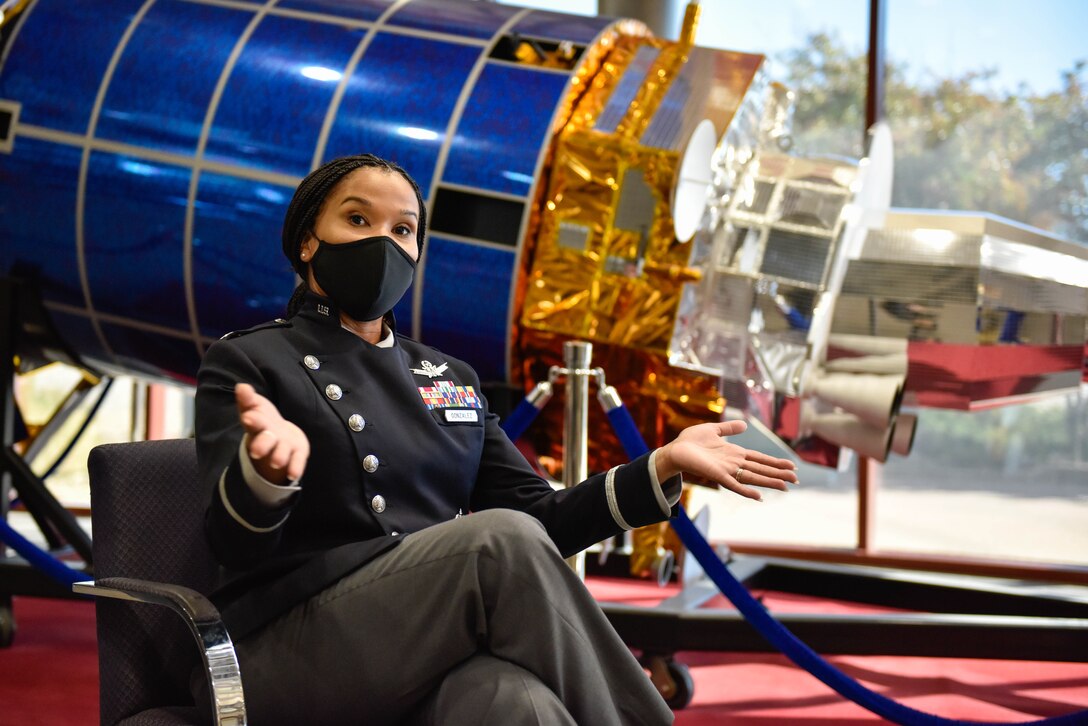 U.S. Space Force Lt. Col. Alison Gonzalez, a member of the Office of the Chief of Space Operations, shows off the elasticity and shorter length of the women's USSF service dress coat prototype on Buckley Space Force Base, Colo., Oct 20, 2021. The new service dress was first designed for females then adapted to men to lower the cost of tailoring for female Guardians. (U.S. Space Force photo by Airman 1st Class Wyatt Stabler)
