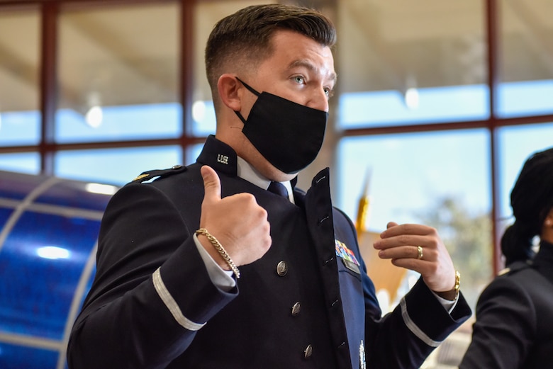 U.S. Space Force Maj. Dylan Caudill reveals the double-breasted coat of the new USSF service dress prototype to Guardians on Buckley Space Force Base, Colo., Oct 20, 2021. The service dress prototype features a double-breasted front which allows for the coat to remain taught and professional looking on the wearer at all times. (U.S. Space Force photo by Airman 1st Class Wyatt Stabler)