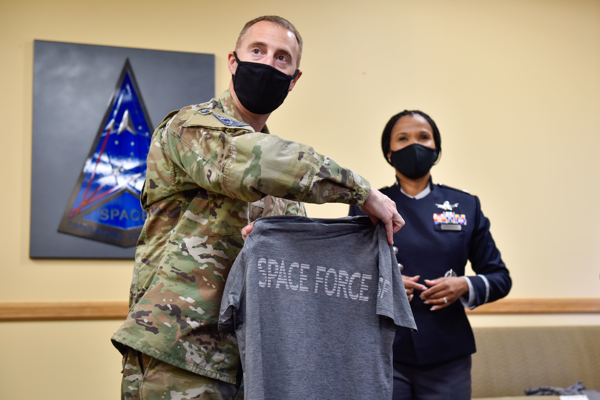 U.S. Space Force Col. Matthew Cantore and Lt. Col. Alison Gonzalez, both from the Office of the Chief of Space Operations, reveal a prototype of the new USSF physical training uniform to members of Space Delta 4's geographically-separated units over Zoom on Buckley Space Force Base, Colo., Oct 20, 2021. The prototypes are being shown to Guardians around the force to ensure maximum satisfaction with the finished product. (U.S Space Force photo by Airman 1st Class Wyatt Stabler)