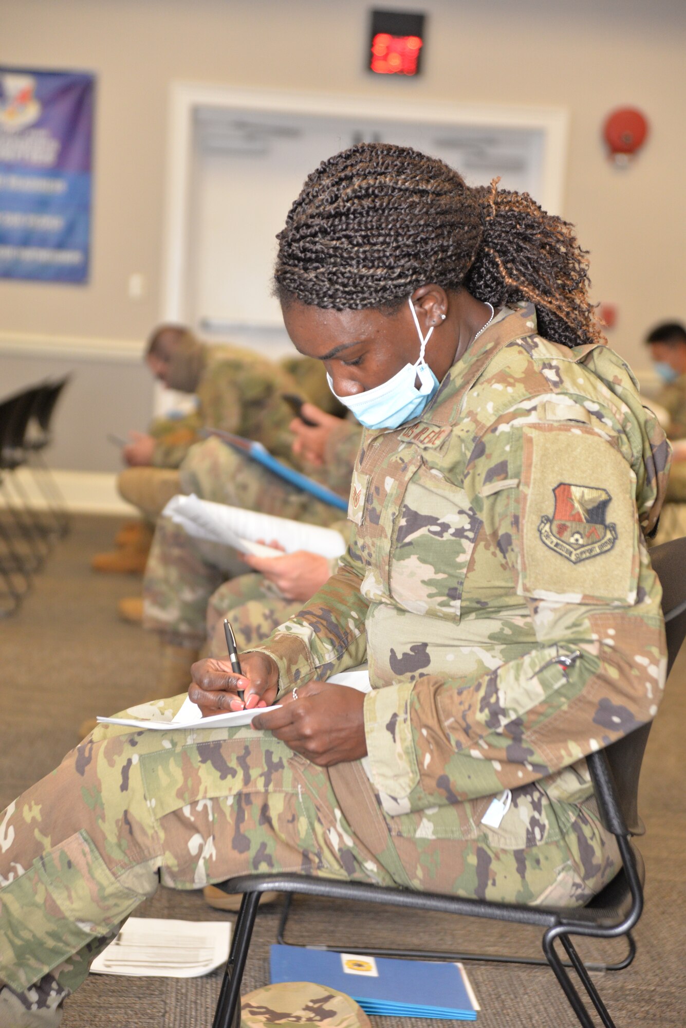 Airman sits and fills out paperwork.