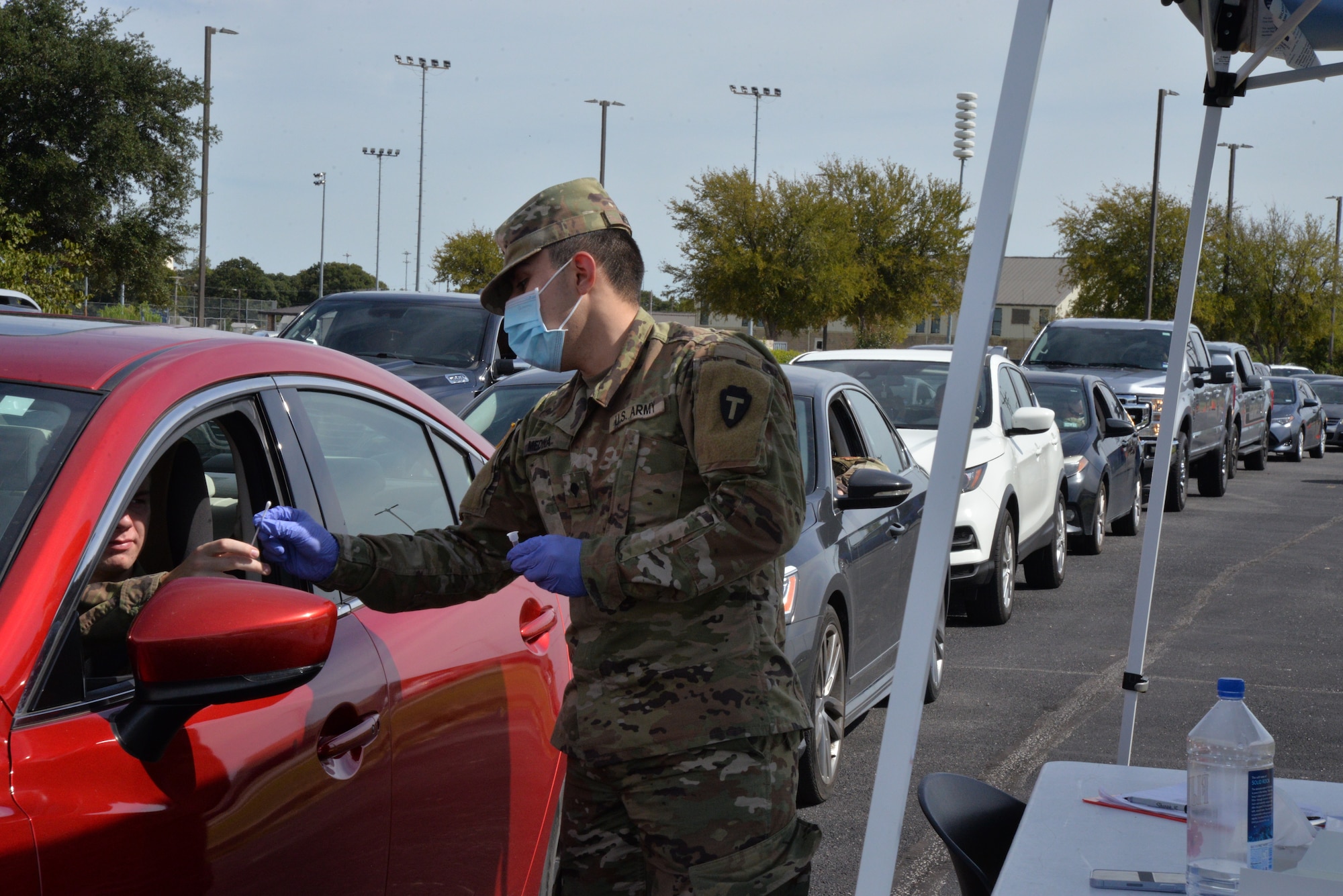 Airman hands out a COVID test swab.