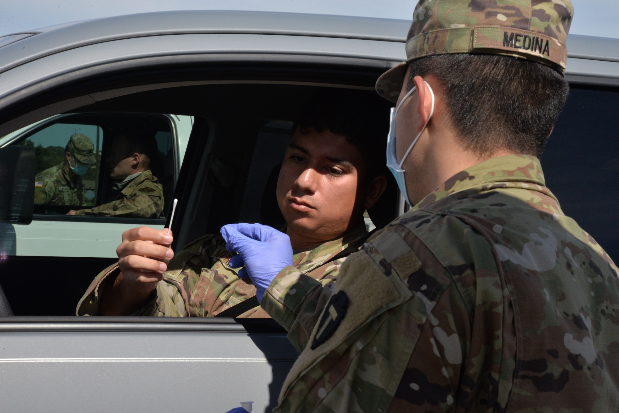 Airman takes testing swab.