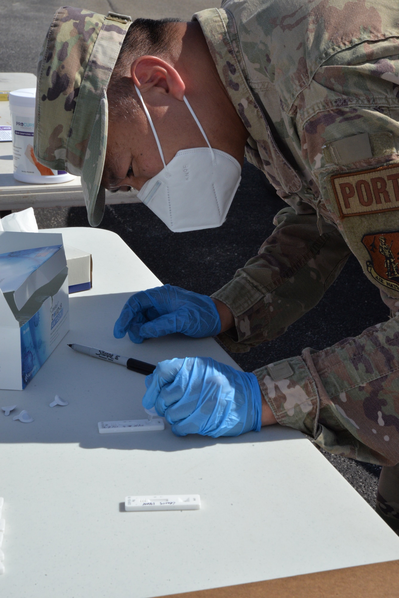 Soldier preps COVID test strip.