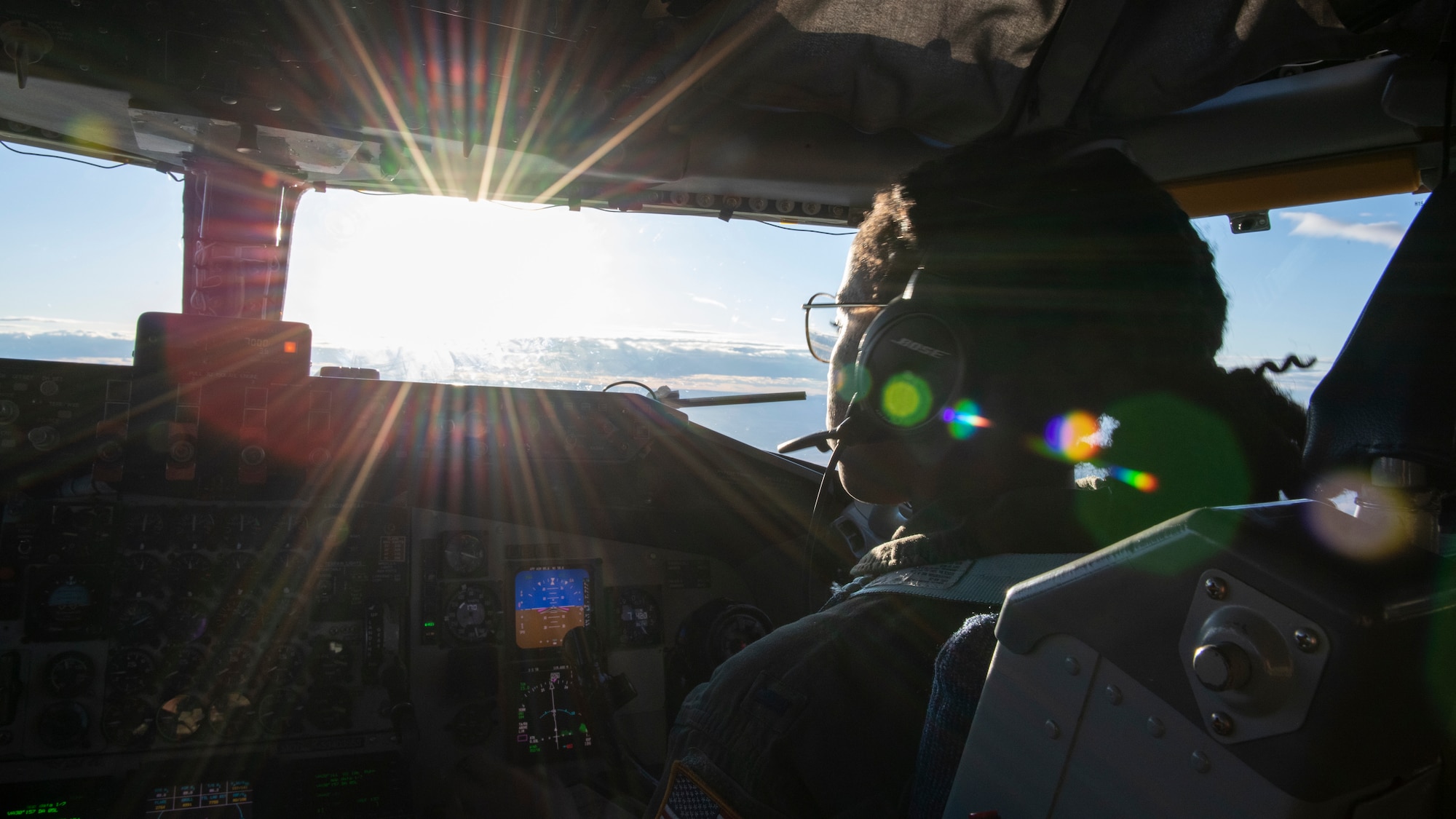 U.S. Air Force 1st Lt. Orchydia Sackey, a 50th Air Refueling Squadron pilot looks through a cockpit window in a KC-135 Stratotanker aircraft during flight, Oct. 15, 2021.